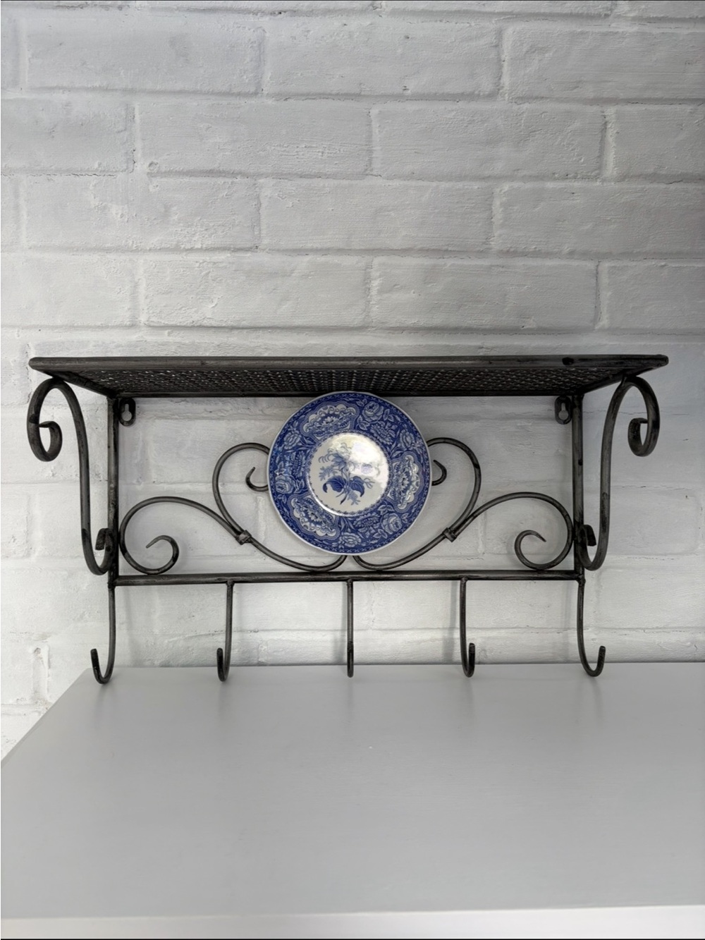 Black Wrought Iron Wall Shelf with Hooks and Decorative Blue Plate - Picture 4 of 12